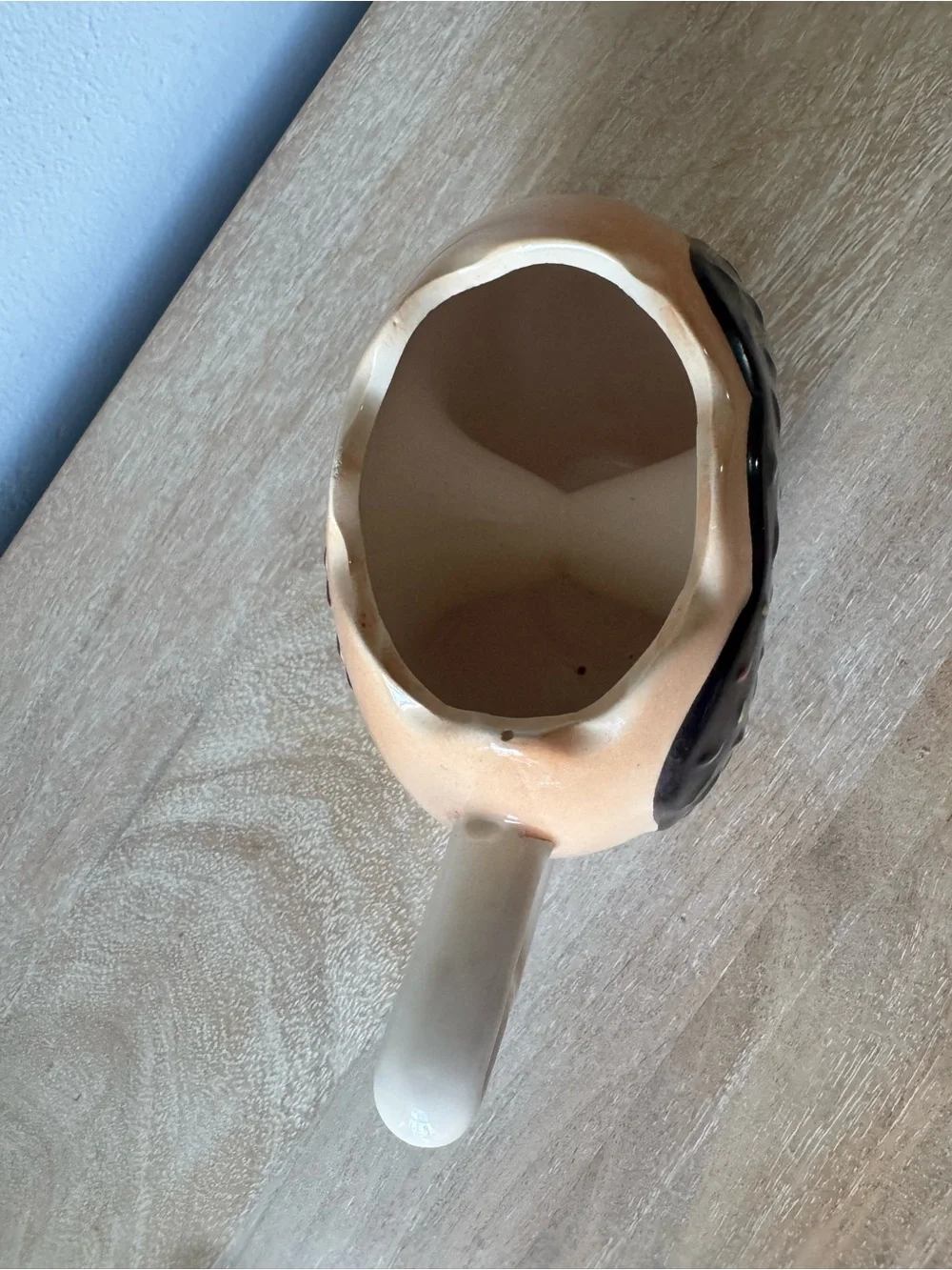 Donut-Shaped Ceramic Mug with Black Frosting and Tan Body